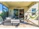 Relaxing covered patio with stylish outdoor furniture, ideal for lounging and enjoying the serene backyard environment at 11479 Satire St, Orlando, FL 32832