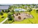 Community playground aerial view, with a variety of play equipment and seating surrounded by lush landscaping at 11479 Satire St, Orlando, FL 32832