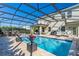Stunning enclosed pool and patio area, complete with outdoor seating, a grill, and a relaxing hammock, perfect for entertainment at 11479 Satire St, Orlando, FL 32832