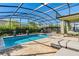Inviting enclosed pool area with comfortable lounge seating and lush landscaping, creating a perfect outdoor retreat at 11479 Satire St, Orlando, FL 32832