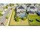 Aerial view of a private screened-in pool and solar panels on roof at 11479 Satire St, Orlando, FL 32832