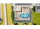 Aerial view of a screened-in pool with hot tub and seating area at 11479 Satire St, Orlando, FL 32832