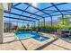 Sparkling enclosed pool with a spa, surrounded by a paved deck and lush landscaping, creating a private oasis at 11479 Satire St, Orlando, FL 32832