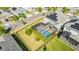 An aerial view shows a screened-in pool and solar panels on roof at 11479 Satire St, Orlando, FL 32832