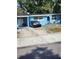 Modest blue home featuring a long driveway with a car parked in front at 1245 Emeralda, Orlando, FL 32808