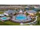 Aerial view of a large community pool with many lounge chairs, surrounding greenery, and ample seating at 14335 Sapelo Beach Dr, Orlando, FL 32827