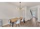 Elegant dining area featuring a modern chandelier and a wooden dining table at 14335 Sapelo Beach Dr, Orlando, FL 32827