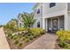 Inviting townhome showcasing landscaped front yard with blooming crape myrtle and covered porch at 14335 Sapelo Beach Dr, Orlando, FL 32827