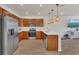 Well-equipped kitchen with stainless appliances, white countertops, and hanging pendant lighting at 14335 Sapelo Beach Dr, Orlando, FL 32827