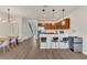 Modern kitchen with stainless appliances, a quartz countertop island, and three pendant lights at 14335 Sapelo Beach Dr, Orlando, FL 32827
