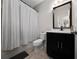 Bathroom features a black vanity, white toilet and gray and white shower curtain at 15693 Kinnow Mandarin Ln, Winter Garden, FL 34787