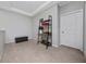 Bedroom with beige carpet, light gray walls, a tray ceiling and a small desk with shelves at 15693 Kinnow Mandarin Ln, Winter Garden, FL 34787