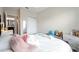 Bedroom features a white bed, stuffed animals, a makeup table and view into the bathroom at 15693 Kinnow Mandarin Ln, Winter Garden, FL 34787