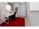 Bedroom with red carpet, light gray walls, white desk and shelves with figures and books at 15693 Kinnow Mandarin Ln, Winter Garden, FL 34787