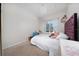 Bedroom with beige carpet, light gray walls, a tray ceiling and white bedding at 15693 Kinnow Mandarin Ln, Winter Garden, FL 34787