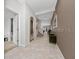 Spacious entryway featuring tile floors, neutral paint, and archways to the staircase and main rooms at 15693 Kinnow Mandarin Ln, Winter Garden, FL 34787