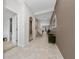 Inviting hallway with tile flooring, decorative mirrors, and convenient access to various rooms at 15693 Kinnow Mandarin Ln, Winter Garden, FL 34787