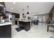 Open-concept kitchen with dark cabinets, stainless steel appliances, and views of the dining area at 15693 Kinnow Mandarin Ln, Winter Garden, FL 34787