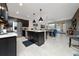 Well-equipped kitchen with a large island, stainless steel appliances, and stylish pendant lighting at 15693 Kinnow Mandarin Ln, Winter Garden, FL 34787