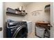 Well-organized laundry room featuring modern washer and dryer, and shelving at 15693 Kinnow Mandarin Ln, Winter Garden, FL 34787