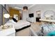 Spacious main bedroom featuring modern decor, tv, and lots of natural light at 15693 Kinnow Mandarin Ln, Winter Garden, FL 34787