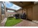 Enclosed outdoor patio with seating, artificial turf, pavers, landscaping rocks, and cooking grills at 15693 Kinnow Mandarin Ln, Winter Garden, FL 34787