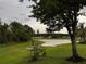 View of the spacious backyard and lake behind the property at 1639 Corner Meadow Cir, Orlando, FL 32820