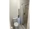Bathroom features a shower with gray and white tile, and a grab bar for accessibility at 1639 Corner Meadow Cir, Orlando, FL 32820