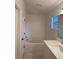 Bright bathroom with a soaking tub, updated vanity with modern fixtures, and window at 1639 Corner Meadow Cir, Orlando, FL 32820
