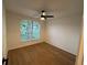 Bright bedroom featuring a ceiling fan and a large window at 1639 Corner Meadow Cir, Orlando, FL 32820