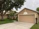 Charming home featuring a two-car garage and well-maintained landscaping at 1639 Corner Meadow Cir, Orlando, FL 32820