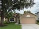 Charming single-story home with a well-maintained lawn, mature trees, and neutral color palette at 1639 Corner Meadow Cir, Orlando, FL 32820