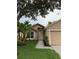 Inviting single-story home with neat landscaping, walkway, and covered entry offers curb appeal at 1639 Corner Meadow Cir, Orlando, FL 32820