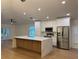 Stylish kitchen with modern white cabinets, stainless appliances, and center island at 1639 Corner Meadow Cir, Orlando, FL 32820