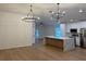 Spacious kitchen with stainless steel appliances, a large island, and modern lighting at 1639 Corner Meadow Cir, Orlando, FL 32820
