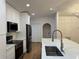 Modern kitchen with stainless steel appliances, white cabinets, and large island at 1639 Corner Meadow Cir, Orlando, FL 32820