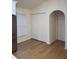Bright living area featuring wood floors, an arched doorway, and a large closet at 1639 Corner Meadow Cir, Orlando, FL 32820