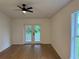 Bright room with hardwood floors, ceiling fan, and access to the patio at 1639 Corner Meadow Cir, Orlando, FL 32820