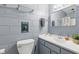 Bathroom with concrete block walls and modern vanity with mirror at 2072 Grandview S Ave, Sanford, FL 32771