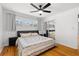 Bright bedroom with hardwood floors, ceiling fan, natural light, and mirrored closet at 2072 Grandview S Ave, Sanford, FL 32771