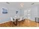 Elegant dining area with hardwood floors, stylish lighting, and access to the bright kitchen at 2072 Grandview S Ave, Sanford, FL 32771