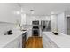 Modern kitchen with white cabinetry, stainless steel appliances, a center island, and hardwood floors at 2072 Grandview S Ave, Sanford, FL 32771