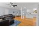 Open-concept living room featuring hardwood floors, a ceiling fan, and a modern kitchen at 2072 Grandview S Ave, Sanford, FL 32771