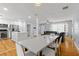 Bright, open living space with hardwood floors, modern lighting, and a stainless steel kitchen at 2072 Grandview S Ave, Sanford, FL 32771