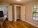 Bright bedroom featuring wood floors and a closet for ample storage at 2181 Wekiwa Oaks Dr, Apopka, FL 32703
