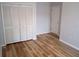 Modern bedroom features a closet providing storage space and wood floors at 2181 Wekiwa Oaks Dr, Apopka, FL 32703