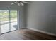Bright bedroom featuring a sliding glass door, fan and vinyl floors with a view of the pool and backyard at 2181 Wekiwa Oaks Dr, Apopka, FL 32703