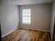 Bright bedroom with modern floors and a light-filled window view at 2181 Wekiwa Oaks Dr, Apopka, FL 32703