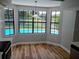 Dining area features hardwood floors and multiple windows with a view of the pool at 2181 Wekiwa Oaks Dr, Apopka, FL 32703