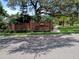 Welcoming entrance to the Oaks of Wekiwa with lush landscaping and a brick sign at 2181 Wekiwa Oaks Dr, Apopka, FL 32703